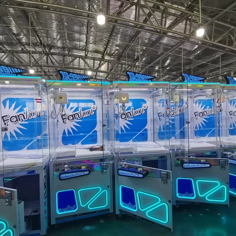 Technician performing maintenance on a commercial claw machine in an arcade