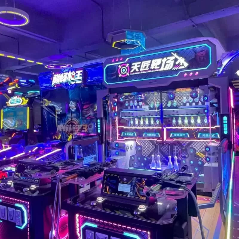 Technician checking electrical grounding and wiring inside a commercial arcade machine